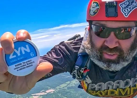 Person Using ZYN Nicotine Pouch Outdoors